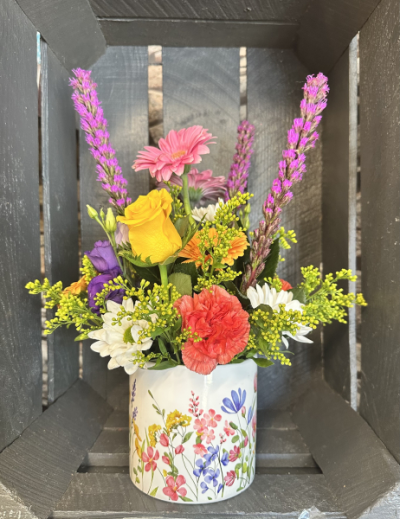 Pot of sunshine - A selection of fresh colorful blooms in a ceramic pot designs may vary