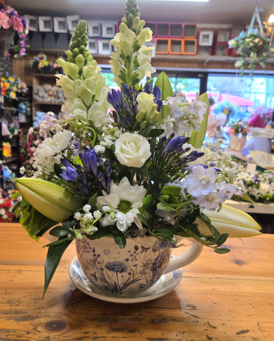 Cup of kindness - A beautiful ceramic cup and saucer with a selection of fresh colorful blooms designs may vary