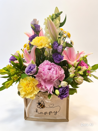 A Little Surprise - Flowers arranged in oasis in a lovely hessian bag colours and bag vary